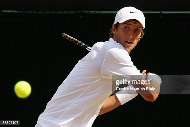 Andrey Kuznetsov of Russia plays a backhand during the boy's singles final match against Jordan Cox of USA on Day Thirteen of the Wimbledon Lawn...