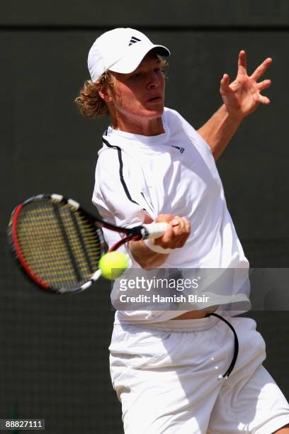Jordan Cox of USA plays a forehand during the boy's singles final match against Andrey Kuznetsov of Russia on Day Thirteen of the Wimbledon Lawn...
