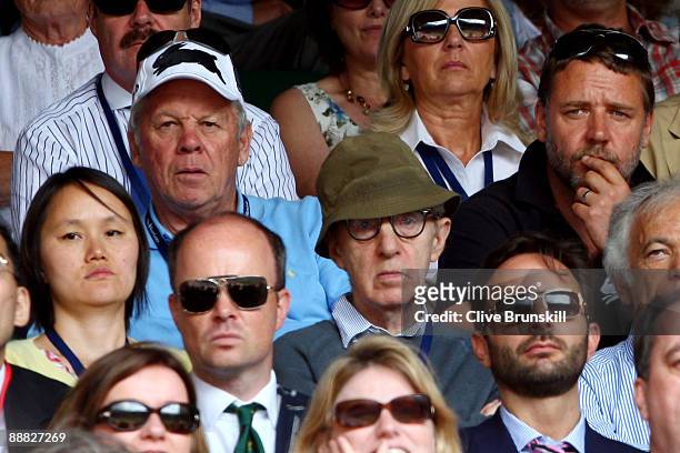 Actor Russell Crowe, director Woody Allen and his wife Soon Yi watch the action during the men's singles final match between Roger Federer of...