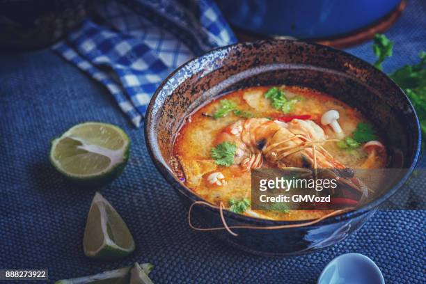 tom yum goong nam kon thai soup with shrimps, enoki mushrooms and fresh chili - enoki mushroom stock pictures, royalty-free photos & images
