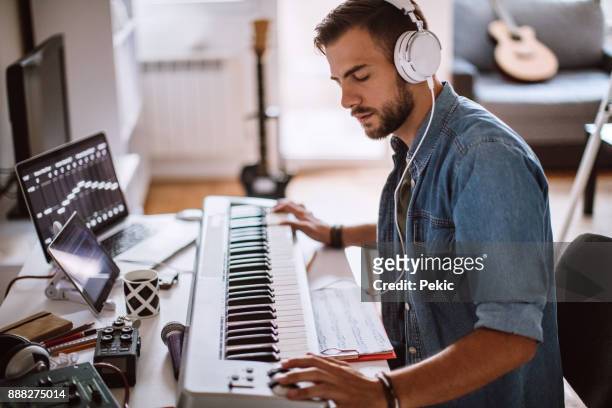 focused young artist playing electric piano - musician stock pictures, royalty-free photos & images