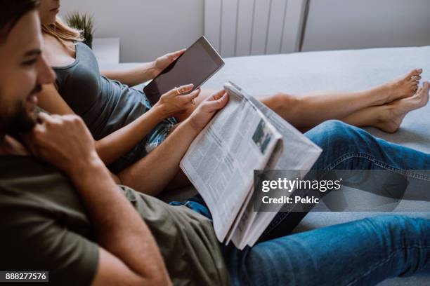 lazy bed time - reading newspaper stock pictures, royalty-free photos & images