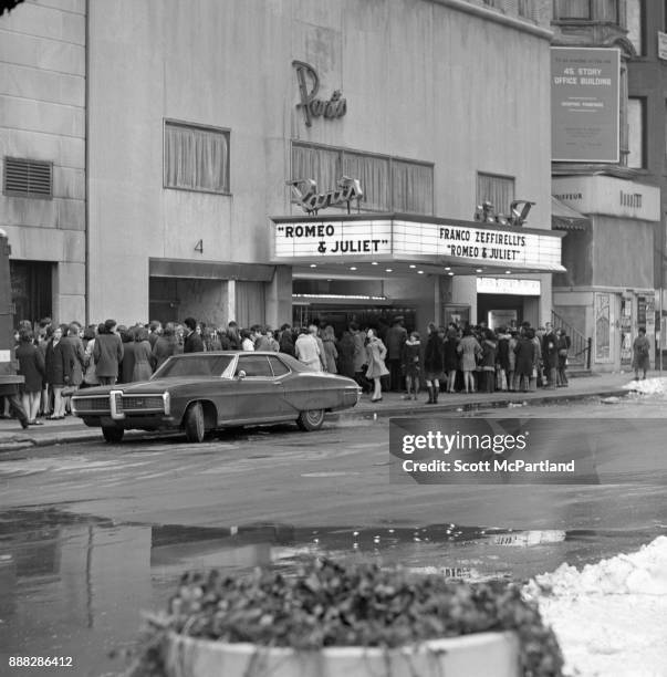 Large crowds of people gather outside the Paris Movie Theater on 58th Street in Manhattan to see Franco Zeffirelli's Romeo and Juliet.