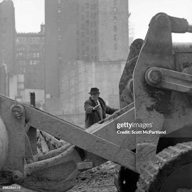 Construction Foreman inspects a bulldozer during the demolition of the Singer Building in Downtown Manhattan, New York.