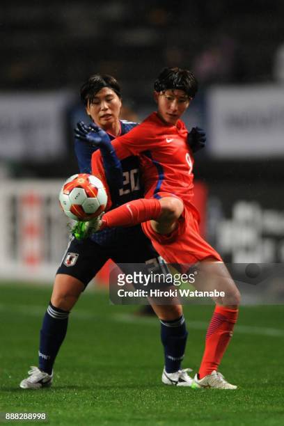 Kang Yumi of South Korea controls the ball under pressure of Miho Manya of Japan during the EAFF E-1 Women's Football Championship between Japan and...