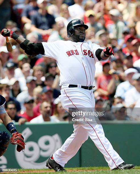 David Ortiz of the Boston Red Sox hits a solo home run in the first inning against the Seattle Mariners on July 5, 2009 at Fenway Park in Boston,...