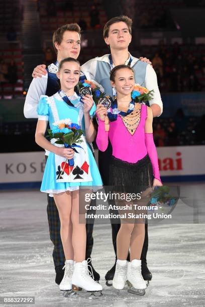 Apollinariia Panfilova and Dmitry Rylov of Russia and Daria Pavliuchenko and Denis Khodykin of Russia pose with their medals after competing in the...