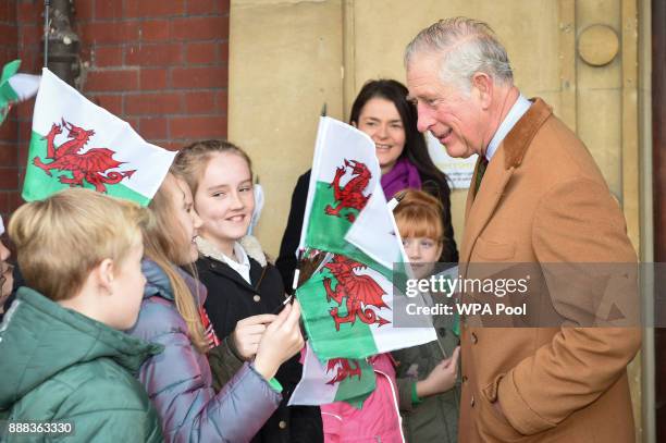 Children from St Cenydd and Cwm Rhymni schools wave Welsh flags as Prince Charles, Prince of Wales arrives for a visit to the Caerphilly Miners...