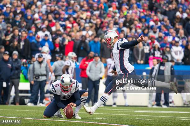 Ryan Allen holds as Stephen Gostkowski of the New England Patriots kicks a field goal during the second quarter against the Buffalo Bills at New Era...