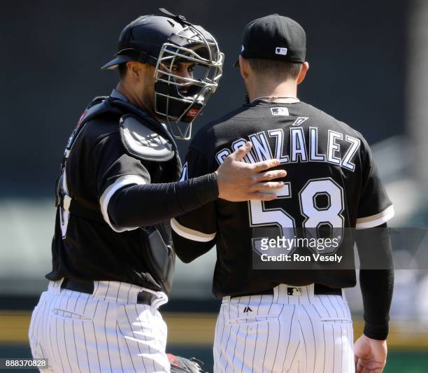 Geovany Soto and Miguel Gonzalez of the Chicago White Sox meet on the mound during the game against the Minnesota Twins at Guaranteed Rate Field on...
