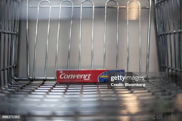 Box of "Convenrt" toothpaste sits in a shopping cart in an arranged photograph at a grocery store in Caracas, Venezuela, on Tuesday, Nov. 28, 2017....