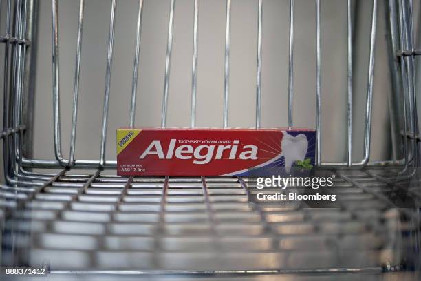 Box of "Alegria" toothpaste sits in a shopping cart in an arranged photograph at a grocery store in Caracas, Venezuela, on Tuesday, Nov. 28, 2017. In...