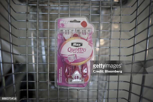 Package of "Quottro" shavers sit in a shopping cart in an arranged photograph at a grocery store in Caracas, Venezuela, on Tuesday, Nov. 28, 2017. In...