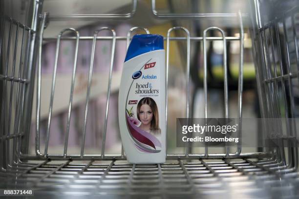 Bottle of "hoed & shouders" sits in a shopping cart in an arranged photograph at a grocery store in Caracas, Venezuela, on Tuesday, Nov. 28, 2017. In...