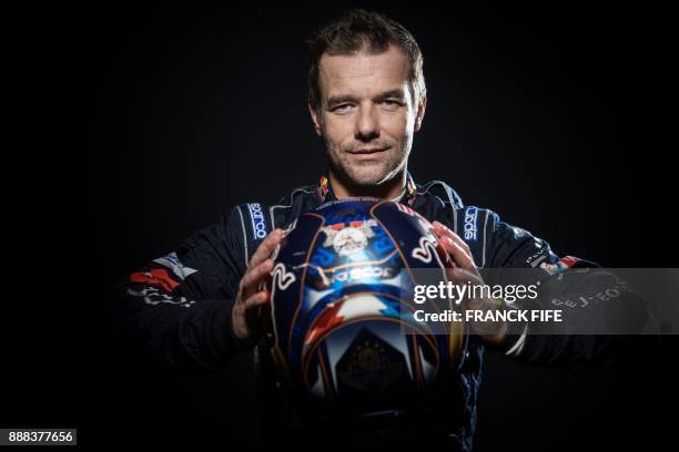 French driver Sebastien Loeb poses during a photo session in Paris on December 7, 2017. / AFP PHOTO / FRANCK FIFE