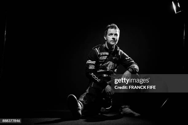 French driver Sebastien Loeb poses during a photo session in Paris on December 7, 2017. / AFP PHOTO / FRANCK FIFE / BLACK AND WHITE VERSION