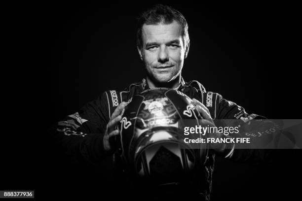 French driver Sebastien Loeb poses during a photo session in Paris on December 7, 2017. / AFP PHOTO / FRANCK FIFE / BLACK AND WHITE VERSION