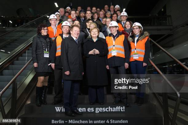 German Chancellor Angela Merkel poses for a group photo after the inauguration of a high-speed ICE train of German state rail carrier Deutsche Bahn...