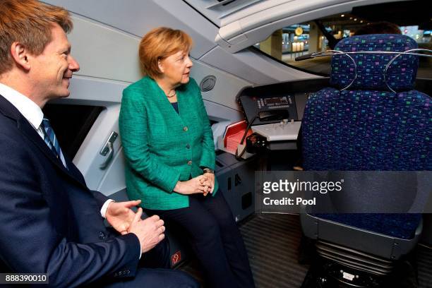 German Chancellor Angela Merkel rides in the train driver's cockpit of a high-speed ICE train of German state rail carrier Deutsche Bahn on the...
