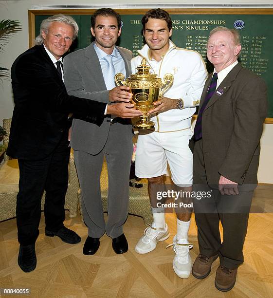 Roger Federer of Switzerland celebrates with the trophy alongside Bjorn Borg , Pete Sampras and Rod Laver after the men's singles final match against...