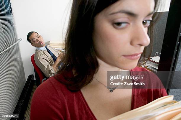 man whistling at woman in office - 性差別 ストックフォトと画像