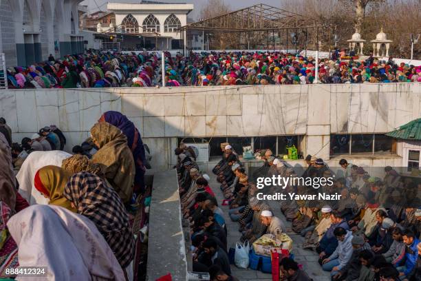 Kashmiri Muslim devotees pray at Hazratbal shrine on the Friday following, Eid-e-Milad , or the birth anniversary of Prophet Mohammad on December 8,...