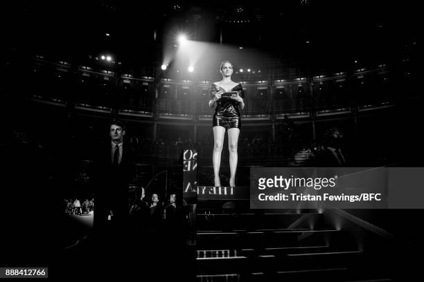 Amber Valletta presents the Accessories Designer of the Year award on stage during The Fashion Awards 2017 in partnership with Swarovski at Royal...