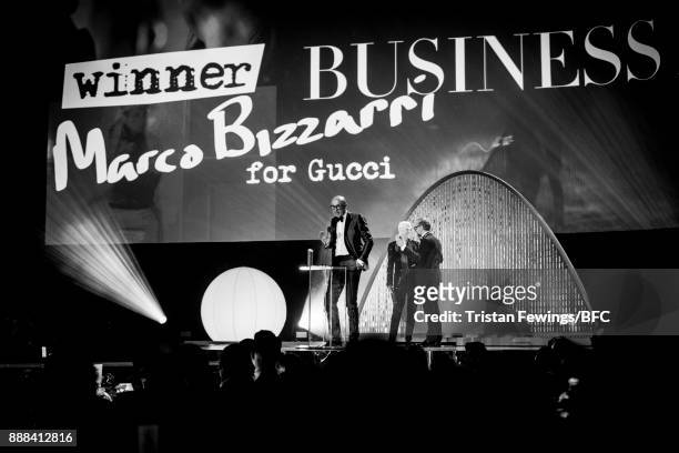 Annie Lennox and Massimo Bottura present Marco Bizzarri for Gucci with the award for Business Leader on stage during The Fashion Awards 2017 in...