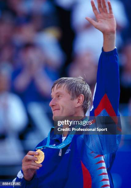 Yevgeny Kafelnikov of Russia waves to the crowd with his gold medal after defeating Tommy Haas of Germany in the Men's Singles Gold Medal Match in...