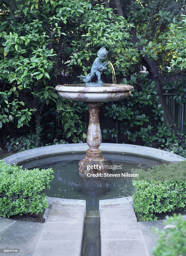 Classical water fountain with statuette