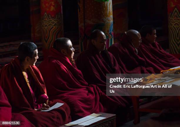 Monks praying and meditating inside Longwu monastery, Tongren County, Longwu, China on October 27, 2017 in Longwu, China.