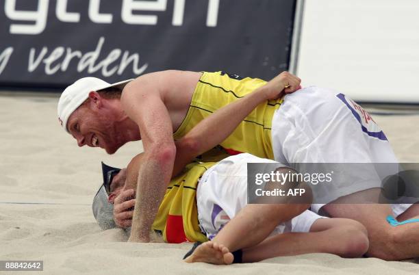 Jonas Reckermann and Julius Brink of Germany celebrate their win against Alison Cerutti and Harley Marques of Brazil at the FIVB Beach Volleyball...