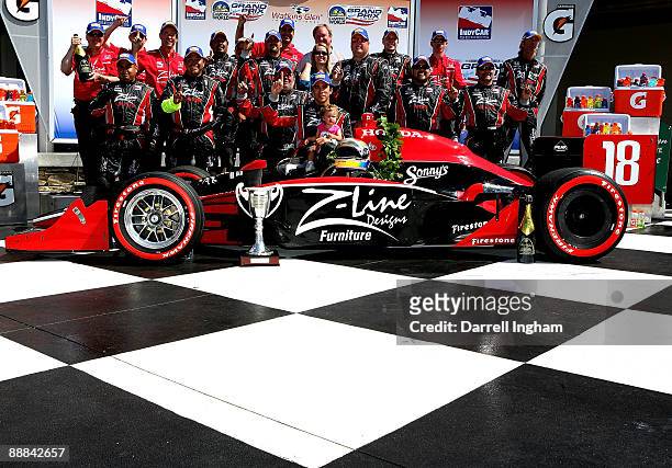 Justin Wilson driver of the Z-Line Design Dale Coyne Racing Dallara Honda celebrates with his team after their first ever victory at the IRL IndyCar...