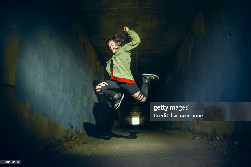 Teenage Girl Jumping in a Tunnel