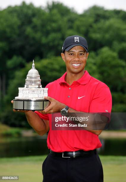 Tiger Woods holds the champion's trophy after winning the final round of the AT&T National at Congressional Country Club on July 5, 2009 in Bethesda,...