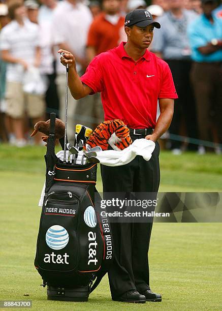 Tiger Woods pulls a club in the 18th fairway during the final round of the AT&T National at the Congressional Country Club on July 5, 2009 in...