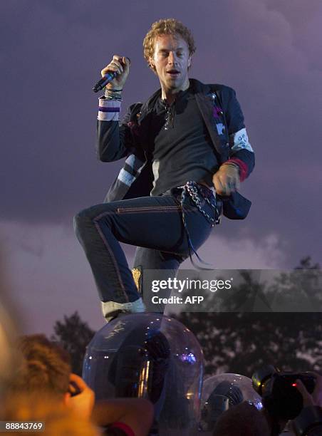 Britain singer Chris Martin in front of Coldplay on July 5 2009 performs on stage at the Roskilde Festival some 30 km west of Copenhagen. Some 60,000...