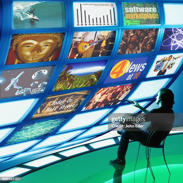 man watching multiple television screens (digital composite) - multiple screens stock pictures, royalty-free photos & images