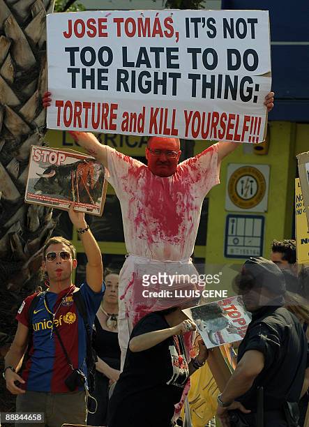 People take part in a demonstration against bullfights outside the Plaza Monumental bullring in Barcelona, on July 5 during a bullfight by Spanish...