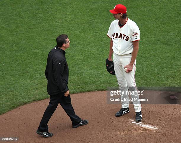 San Francisco Giants Head Athletic Trainer Dave Groeschner visits the mound to remove the injured Randy Johnson of the San Francisco Giants from the...