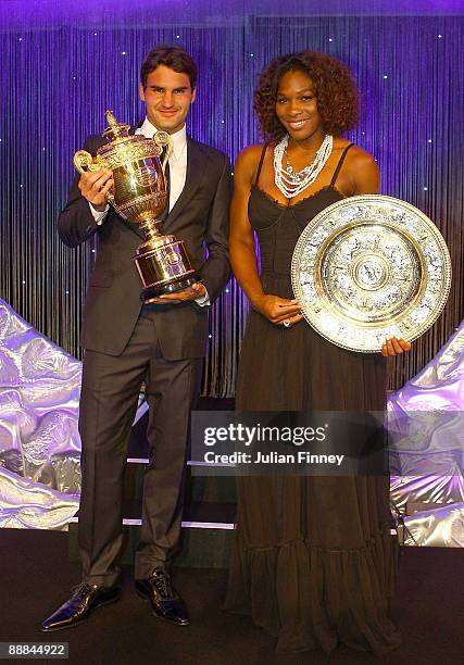 Roger Federer of Switzerland and Serena Williams of United States hold their Trophies at the Hotel Intercontinental on July 5, 2009 in London,...