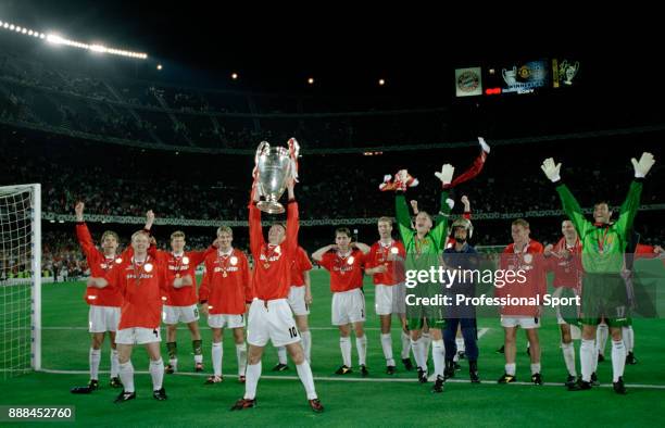 Teddy Sheringham of Manchester United lifts the European Cup surrounded by his team mates after victory in the UEFA Champions League Final between...