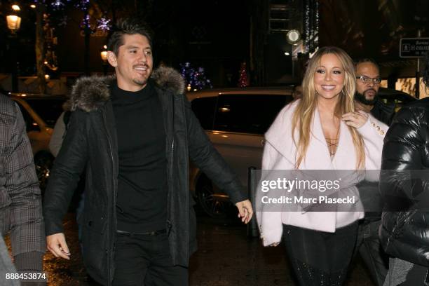 Bryan Tanaka and singer Mariah Carey are seen on Champs-Elysees Avenue on December 8, 2017 in Paris, France.