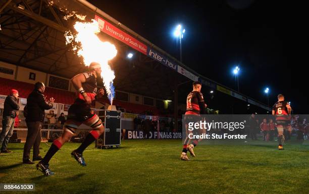 Dragons players run out beside a flame before the European Rugby Challenge Cup match between Dragons and Enisei EM at Rodney Parade on December 8,...