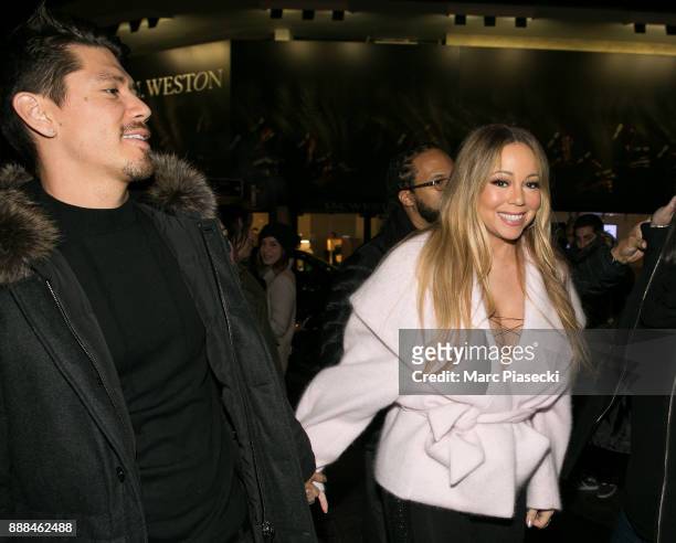 Bryan Tanaka and singer Mariah Carey are seen on Champs-Elysees Avenue on December 8, 2017 in Paris, France.
