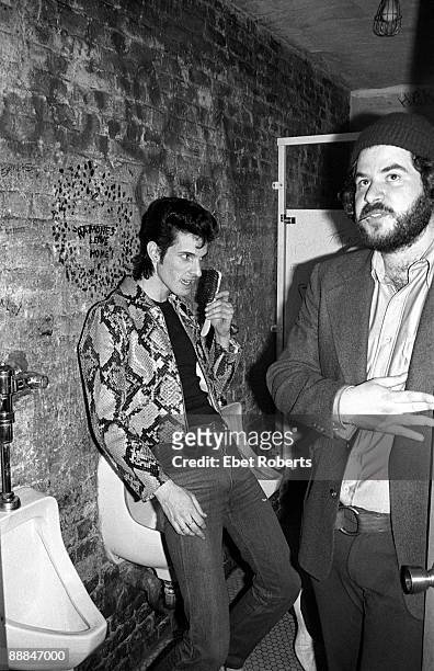Willy DeVille of Mink Deville does his hair in the men's toilet backstage at CBGB's in New York City on May 12,1977.