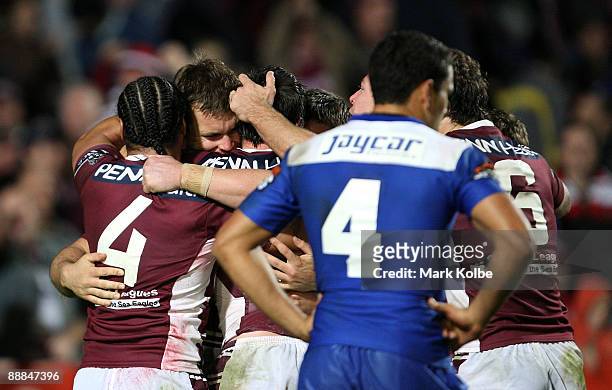 Josh Perry of the Eagles celebrates with his team mates after scoring a try during the round 18 NRL match between the Manly Warringah Sea Eagles and...