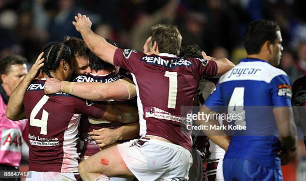 Josh Perry of the Eagles celebrates with his team mates after scoring a try during the round 18 NRL match between the Manly Warringah Sea Eagles and...