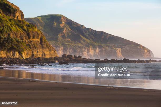 muriwai sunset - black sand stock pictures, royalty-free photos & images