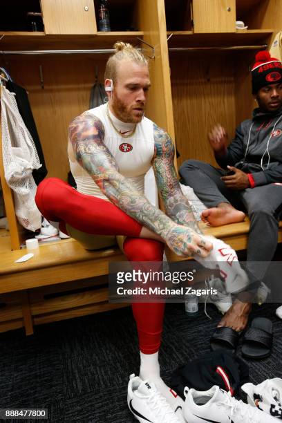 Cassius Marsh of the San Francisco 49ers gets dressed in the locker room prior to the game against the Chicago Bears at Soldier Field on December 3,...